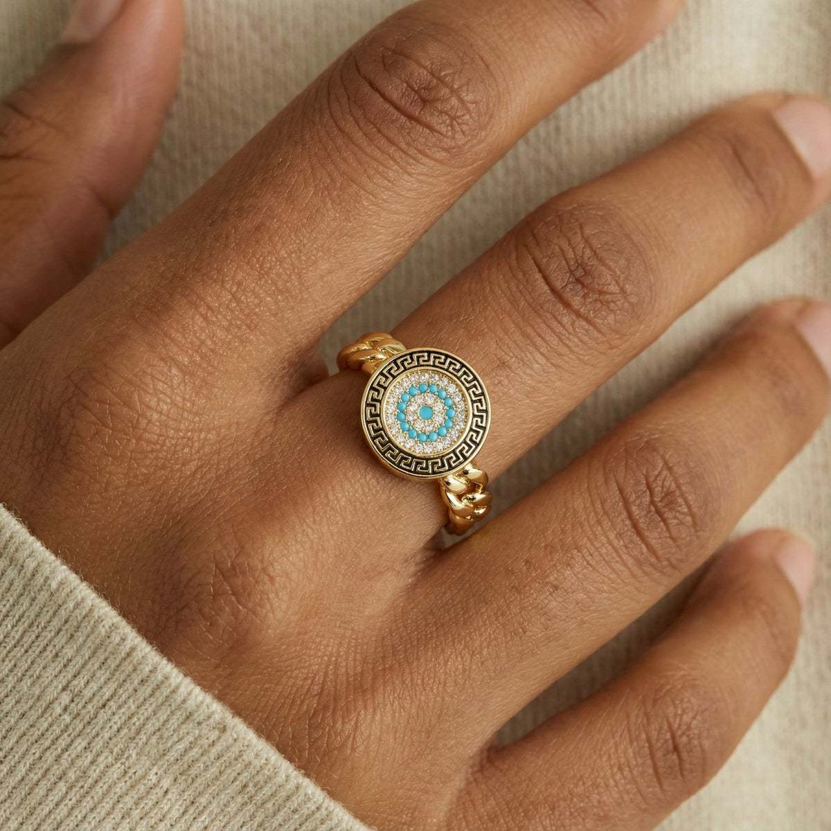 Aegean Evil Eye adjustable ring worn on the hand in gold and turquoise styling