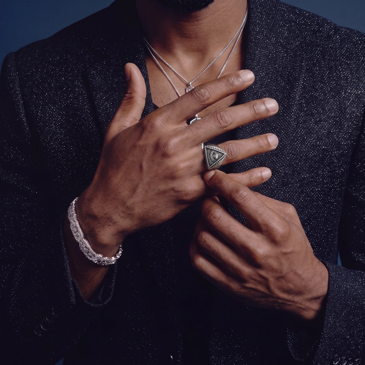Model wearing the All-Seeing Eye celestial signet ring in polished stainless steel