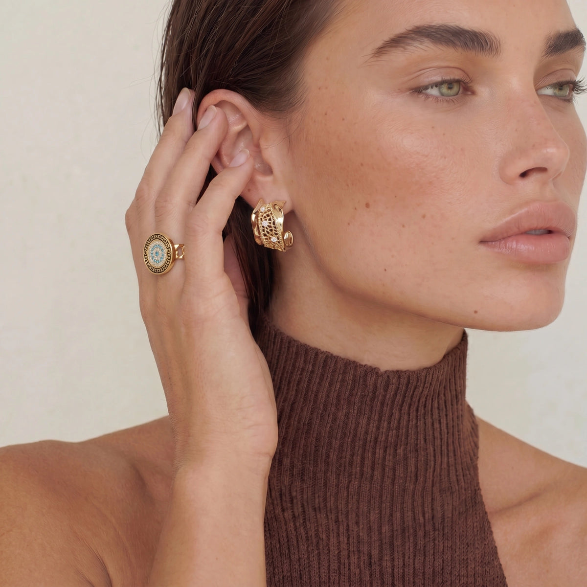 Model wearing the Aegean Evil Eye adjustable ring with 18K gold plated finish