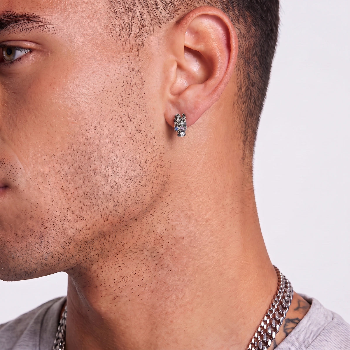 Model wearing the Crowned Skull single stud earring as an asymmetric dark statement look