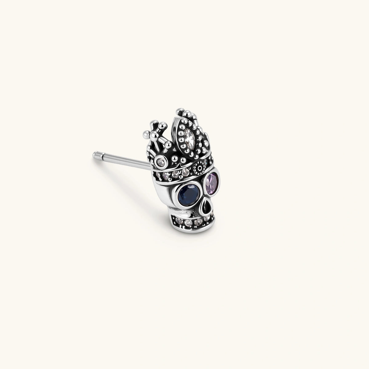 Side view of Crowned Skull single stud earring with antique silver plated texture and crown detailing