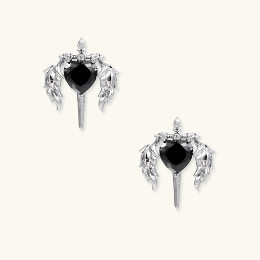 Dark Angel Heart Wing stud earrings with black zirconia heart, silver-toned wings and dagger motif