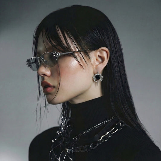 Model wearing Dark Angel Heart Wing stud earrings with black heart and silver-toned wing details
