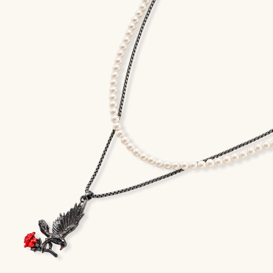 Raven Rose necklace with dark chain, pale pearl-style strand and raven pendant holding a red rose